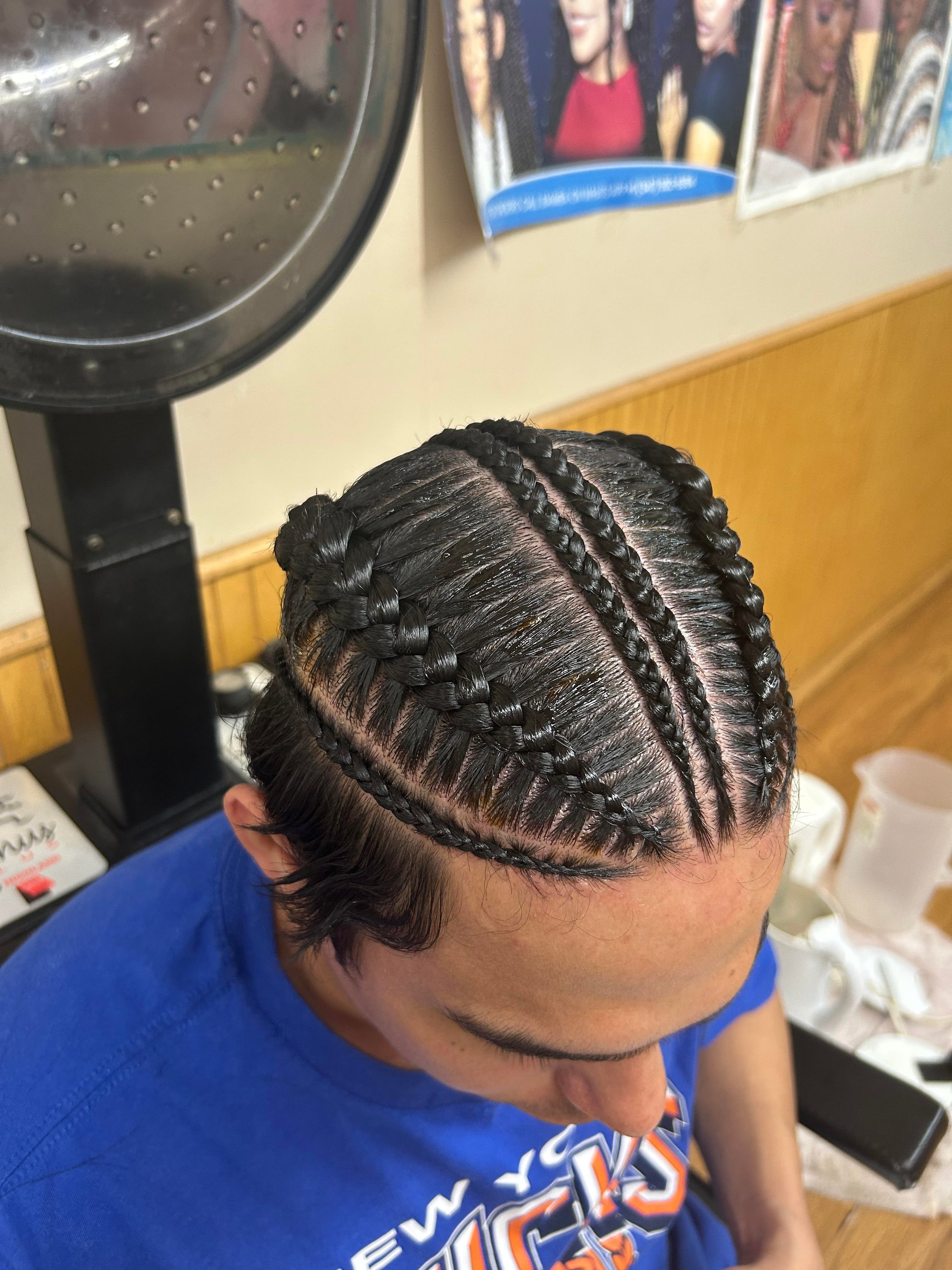Overhead view of intricate cornrow braids on dark hair